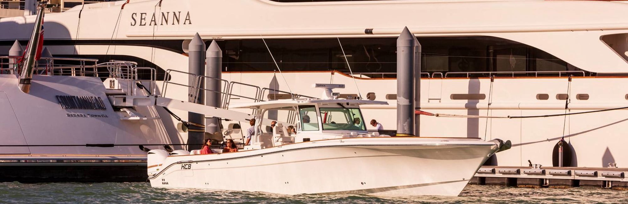 HCB tender alongside a superyacht in a picturesque cove in the Arabian Gulf.